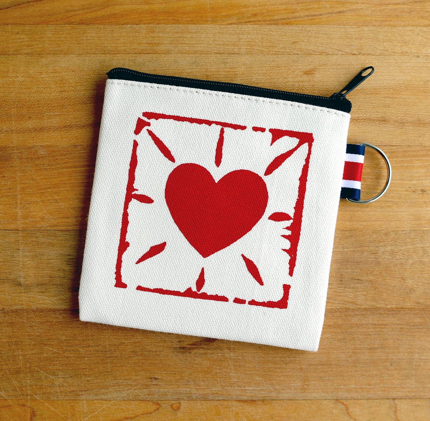 Hand printed canvas coin pouch with red heart design, zipper closure, and keyring tab