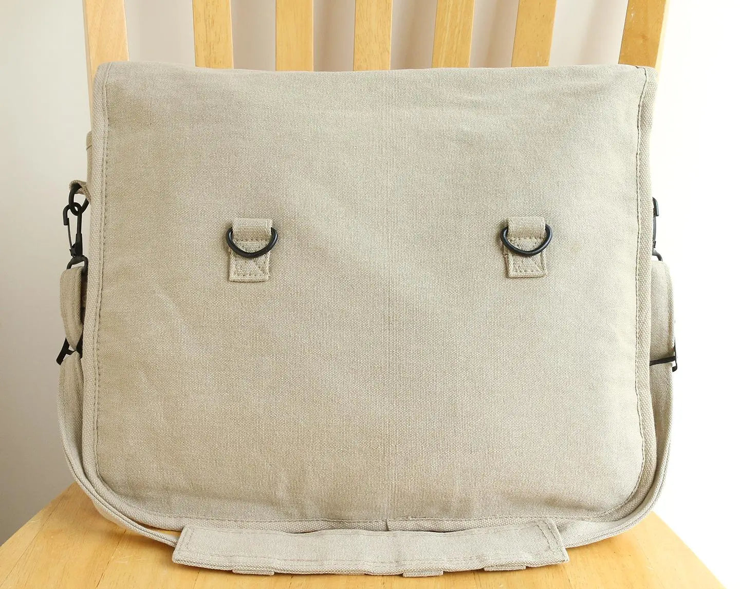 Natural canvas messenger bag with metal rings, minimalist design, hand-printed accessory