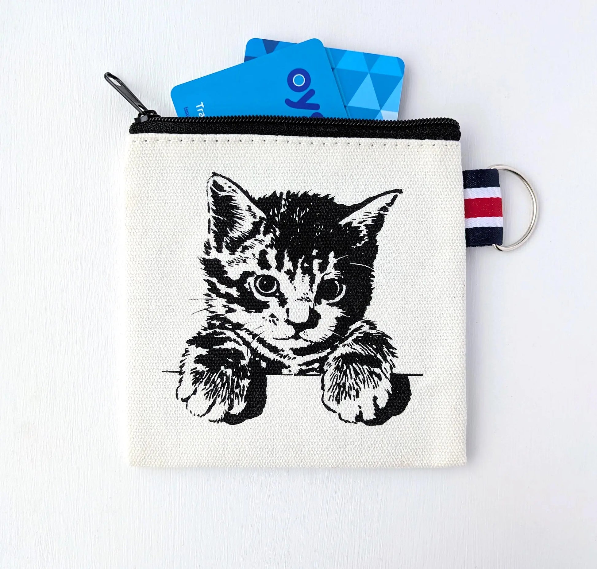 Canvas coin purse with black screen-printed kitten design and striped keyring tab.