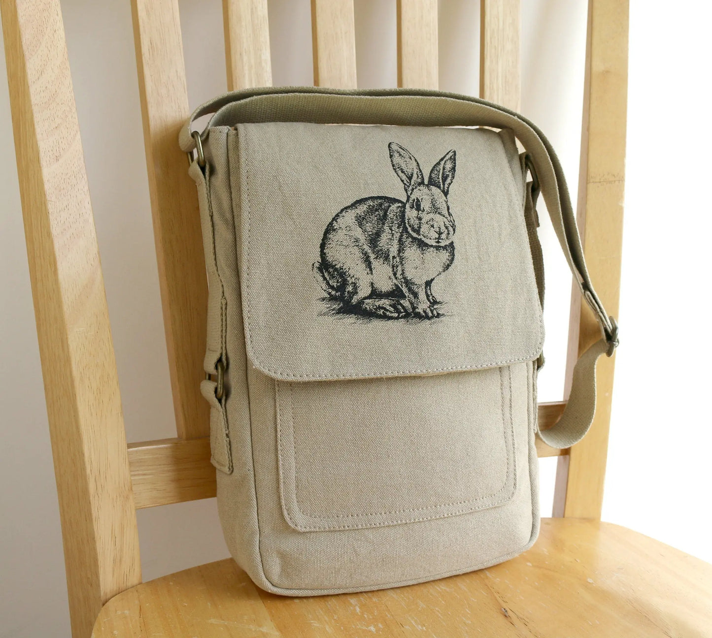 Beige canvas crossbody bag with hand printed rabbit illustration on the front flap